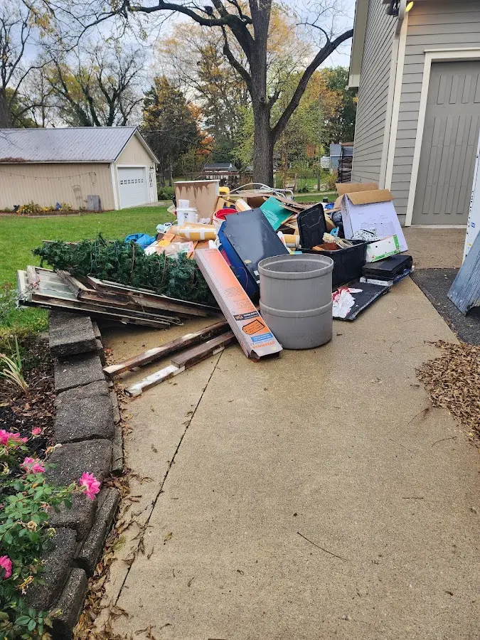 Dumpster being loaded with debris for 10 Yard Dumpster Rental in Clanton